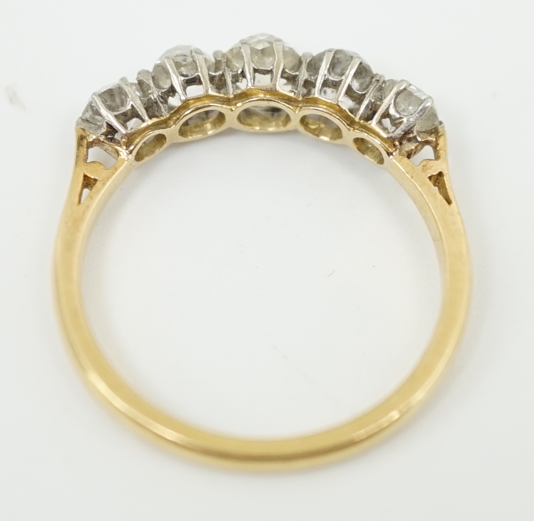 An early to mid 20th century 18ct gold, platinum and graduated five diamond set half hoop ring